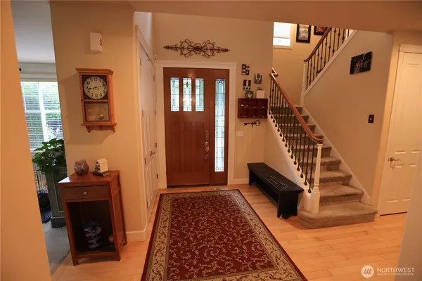 a view of entryway and hall with wooden floor