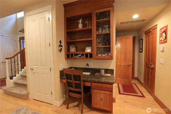a kitchen with a refrigerator and a stove top oven