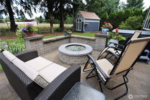 a view of a house with backyard and sitting area