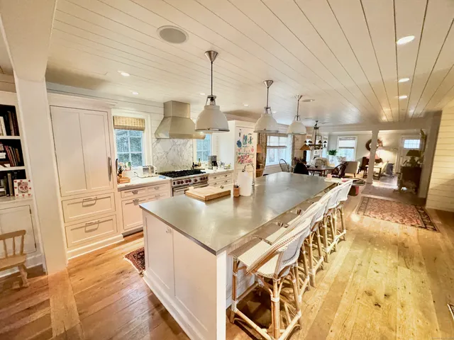 a kitchen with stainless steel appliances granite countertop a sink a counter top space and cabinets