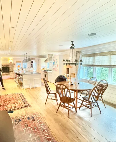 a dining room with furniture and wooden floor