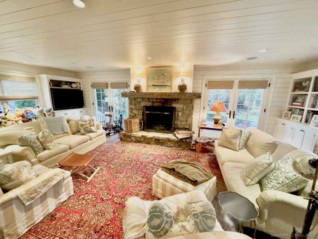 9 Barclay Court Norwalk, CT 06853 - Photo 7 of 16 a living room with furniture a flat screen tv and a fireplace