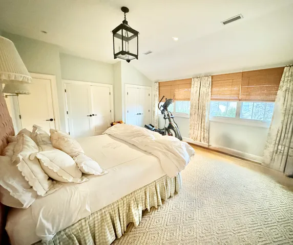 a bedroom with a bed and a large window