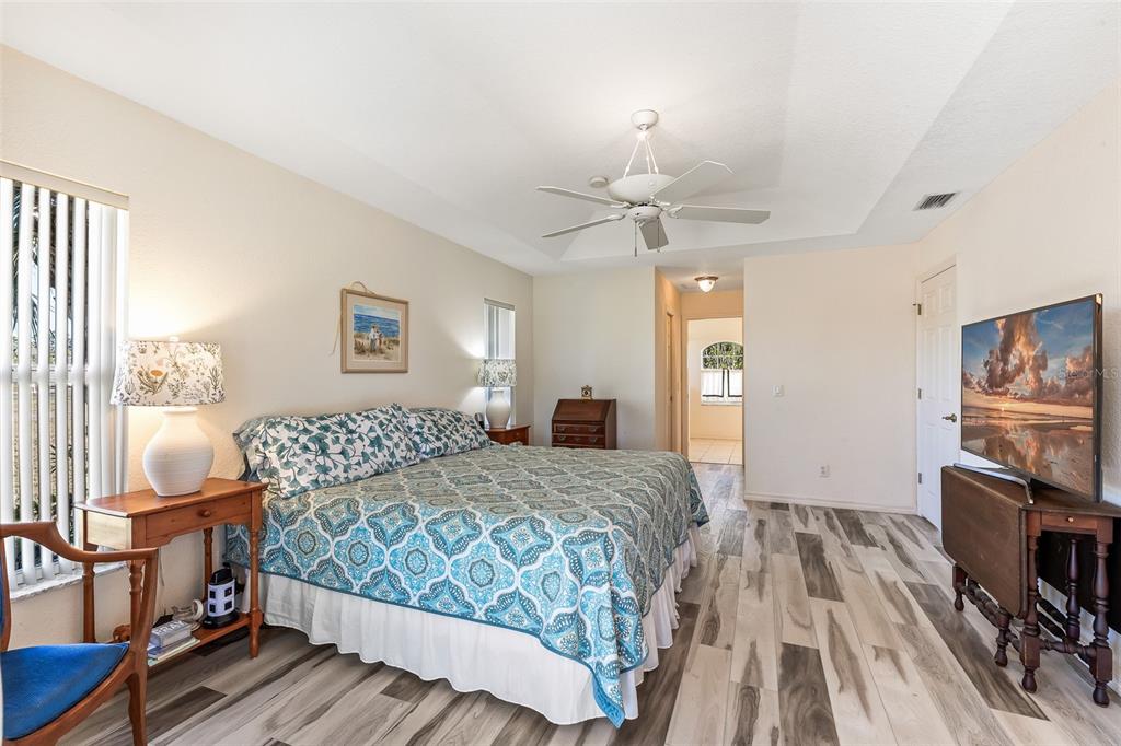 57 Marker Road Rotonda West, FL 33947 - Photo 12 of 27 a bedroom with a bed and a flat screen tv