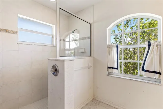 a bedroom with a bed and a view of balcony