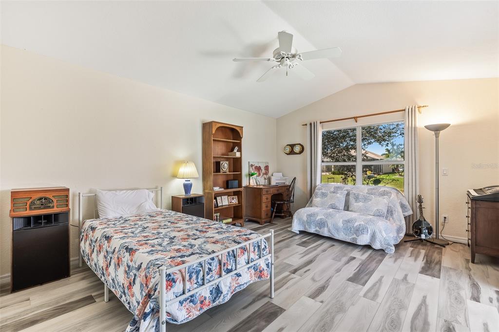 57 Marker Road Rotonda West, FL 33947 - Photo 15 of 27 a bedroom with a large bed and a chandelier