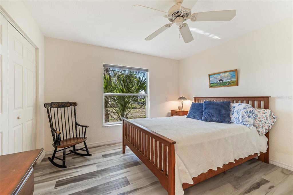 57 Marker Road Rotonda West, FL 33947 - Photo 16 of 27 a bedroom with a bed and a view of balcony
