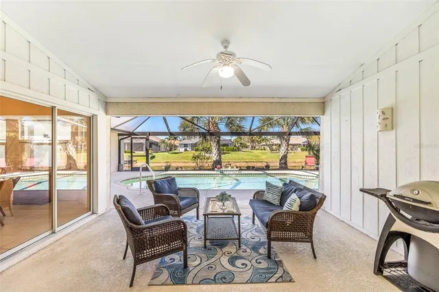 a swimming pool with outdoor seating and yard
