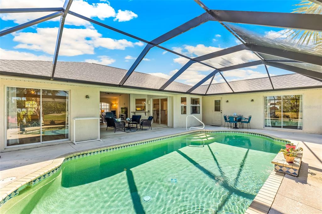 57 Marker Road Rotonda West, FL 33947 - Photo 19 of 27 a house view with a seating space and swimming pool