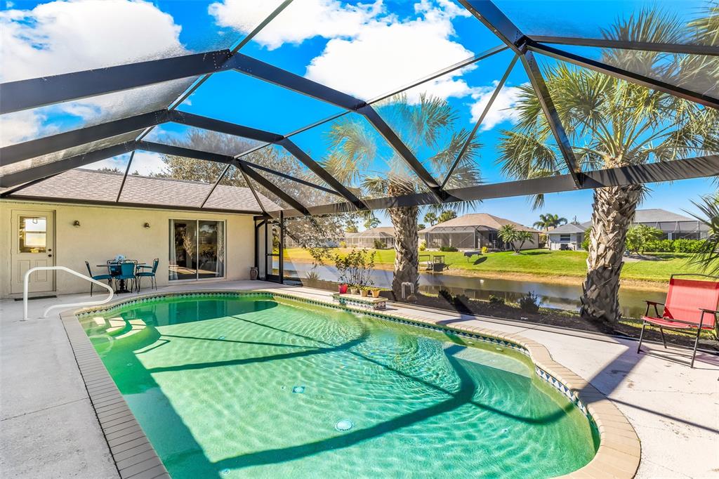 57 Marker Road Rotonda West, FL 33947 - Photo 3 of 27 a view of a swimming pool with a yard and sitting area