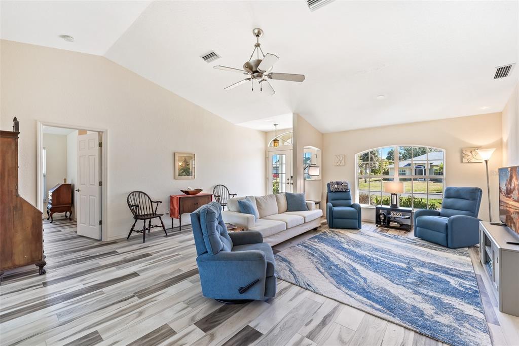 57 Marker Road Rotonda West, FL 33947 - Photo 4 of 27 a living room with furniture dining table and a large window