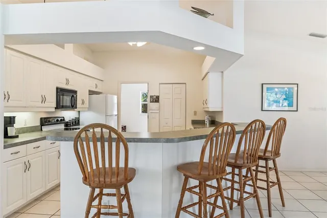 a dining room with furniture and a chandelier