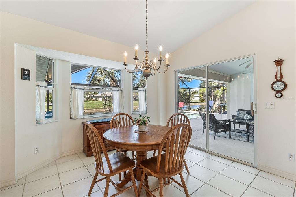 57 Marker Road Rotonda West, FL 33947 - Photo 10 of 27 a dining room with furniture a chandelier and window