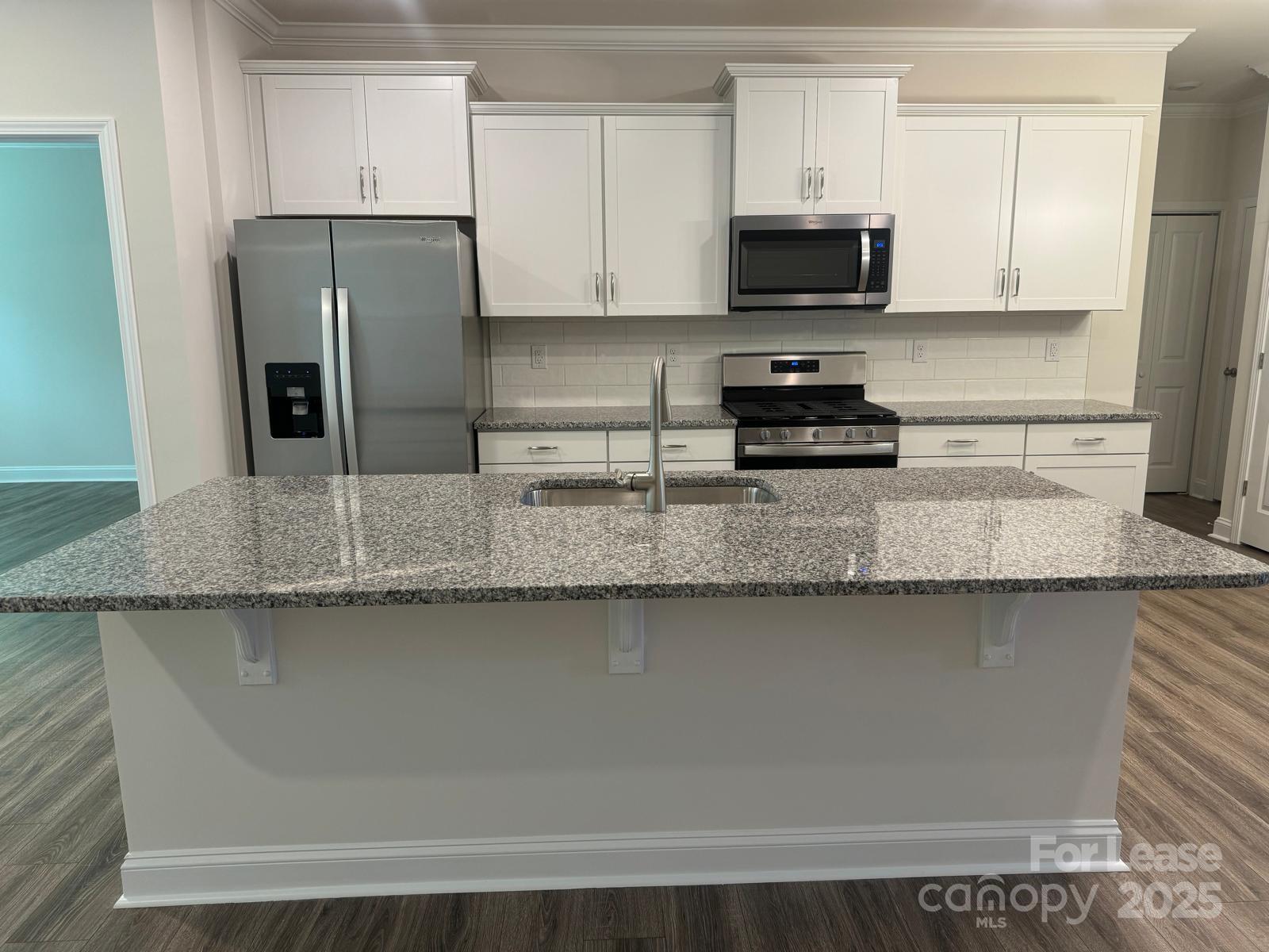 7870 Iron Road Sherrills Ford, NC 28673 - Photo 8 of 22 a kitchen with granite countertop a refrigerator and a stove top oven