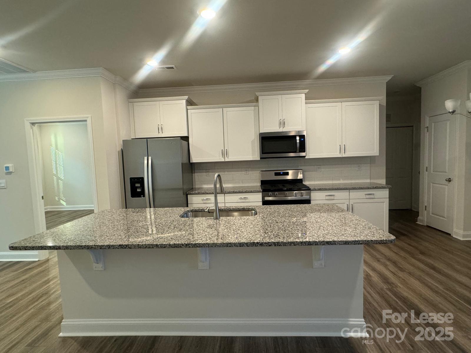 7870 Iron Road Sherrills Ford, NC 28673 - Photo 9 of 22 a kitchen with stainless steel appliances granite countertop a sink a stove a refrigerator a microwave and cabinets