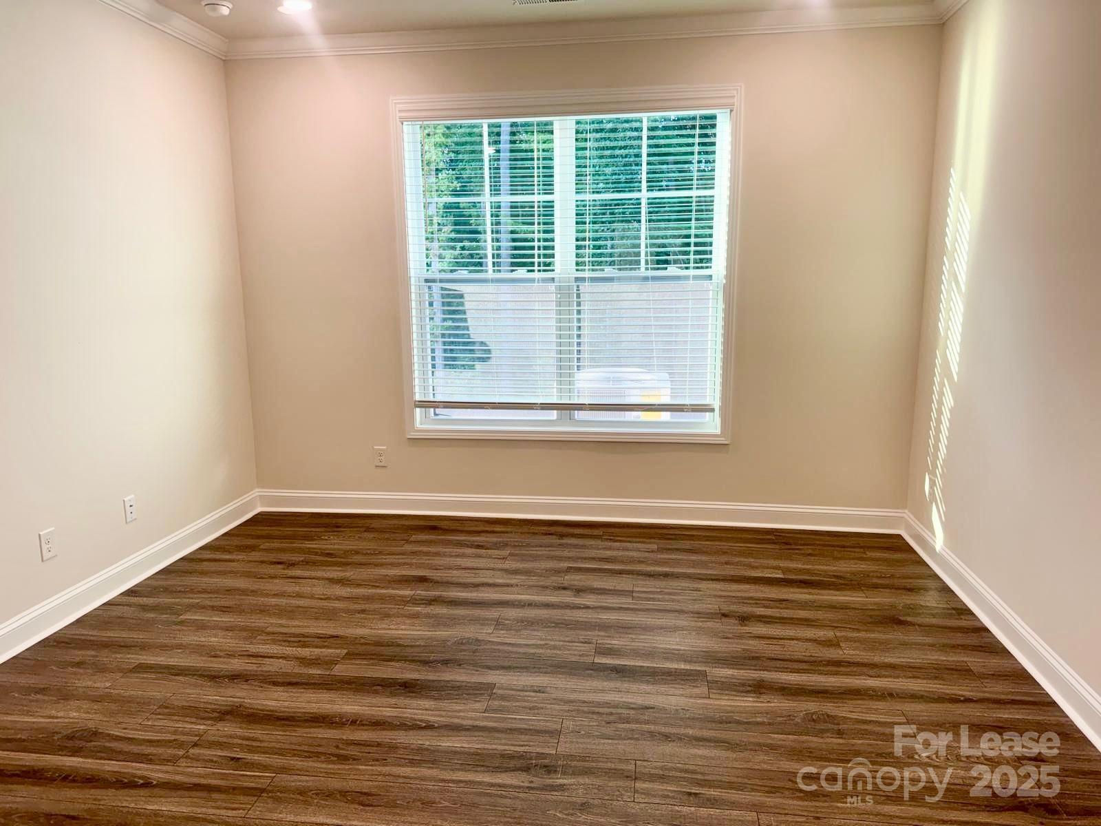 7870 Iron Road Sherrills Ford, NC 28673 - Photo 10 of 22 a view of an empty room with wooden floor and a window