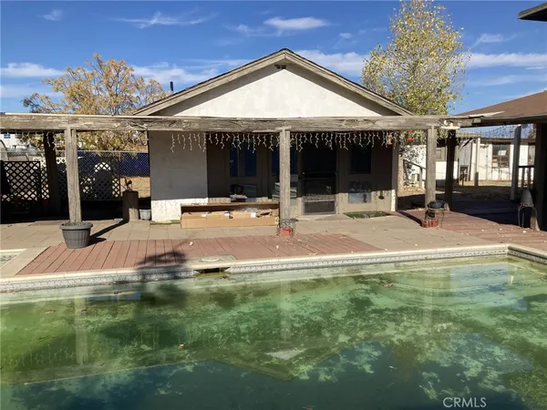 a swimming pool with patio outdoor seating and yard