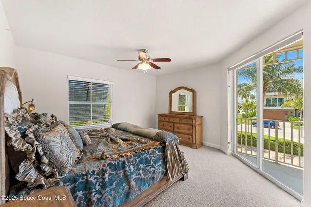 a bedroom with a bed and a large window with outer view