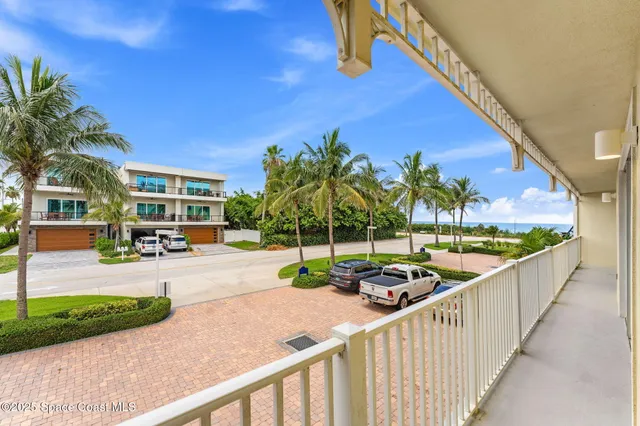 a view of a street with a cars parked in front of it