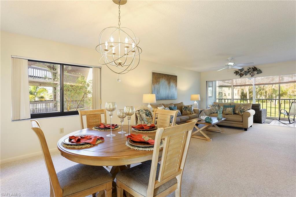 a view of a dining room with furniture wooden floor and chandelier