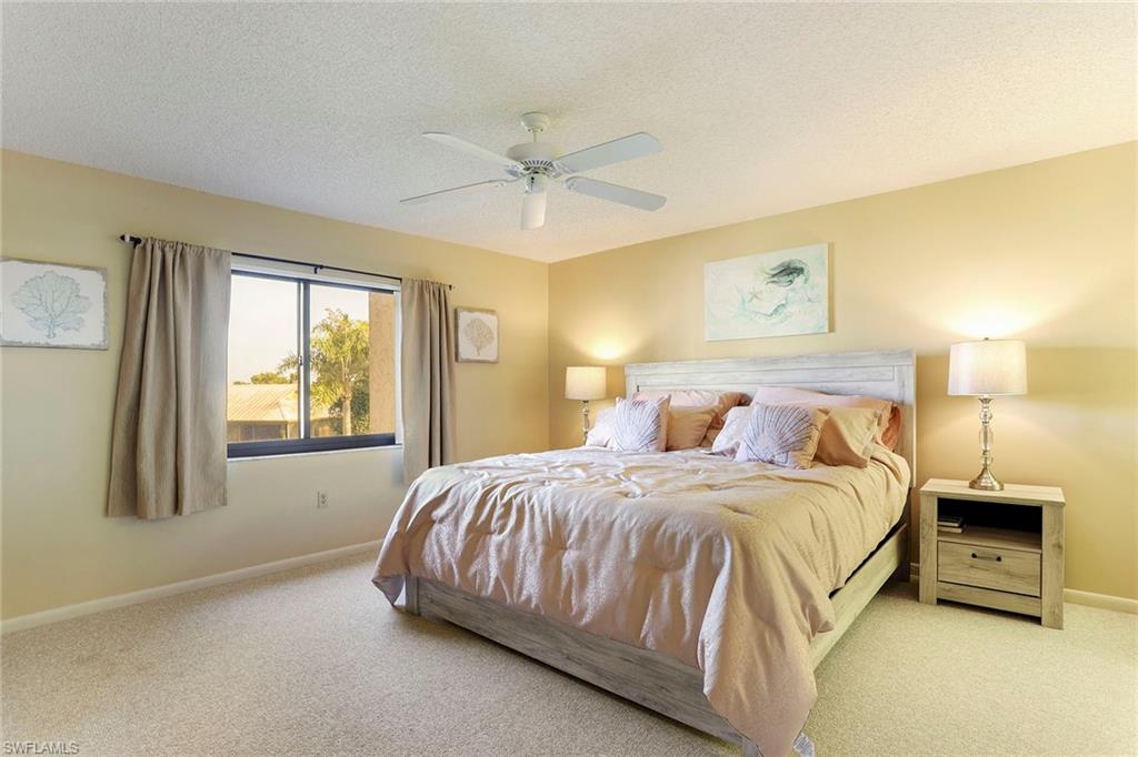 95 St Andrews Boulevard, Unit B209 Naples, FL 34113 - Photo 12 of 18 a bedroom with a bed and a window