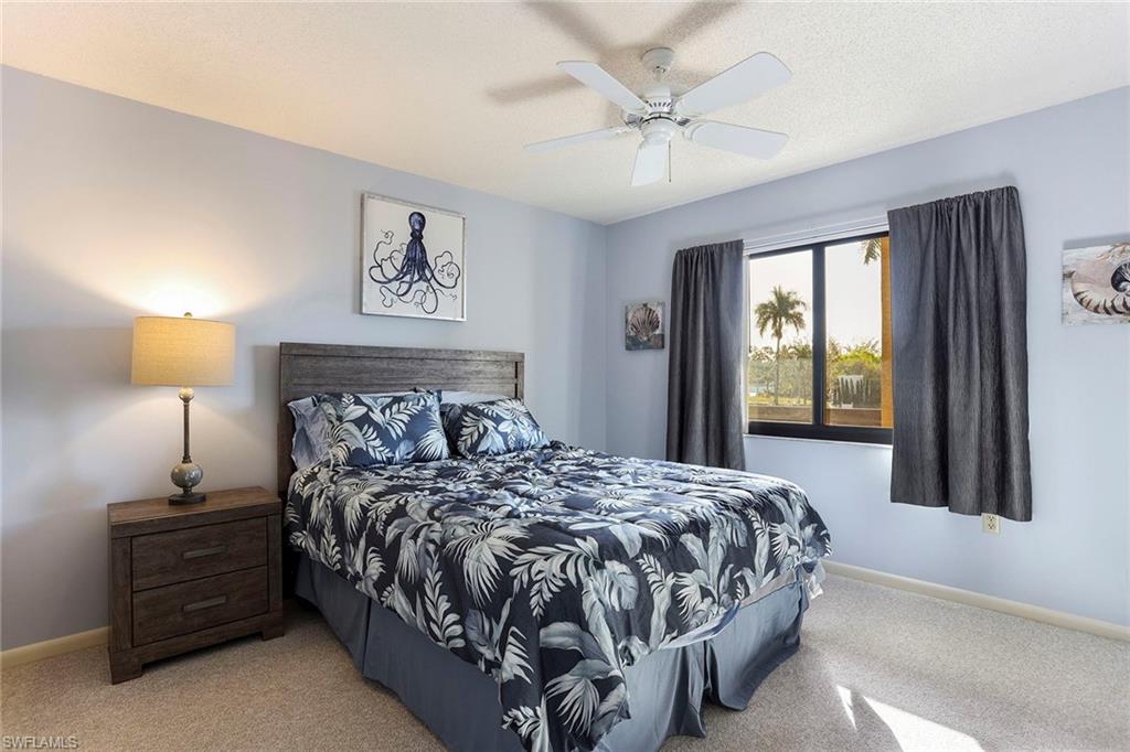 95 St Andrews Boulevard, Unit B209 Naples, FL 34113 - Photo 14 of 18 a bedroom with a bed and a window