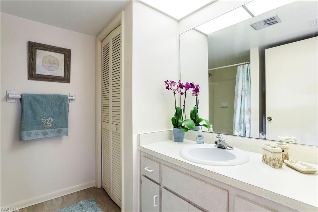 95 St Andrews Boulevard, Unit B209 Naples, FL 34113 - Photo 15 of 18 a bathroom with a sink and a mirror