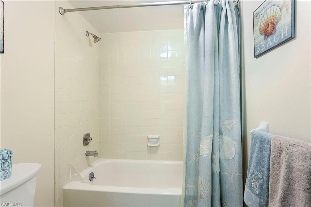 95 St Andrews Boulevard, Unit B209 Naples, FL 34113 - Photo 16 of 18 a bathroom with a bathtub and a shower