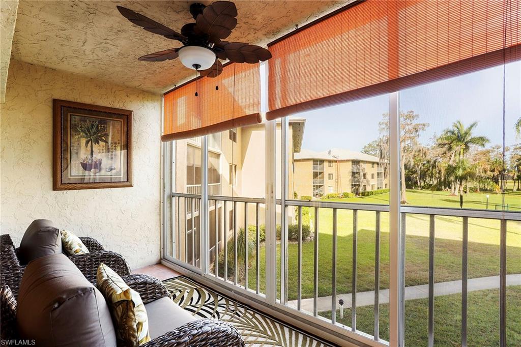 95 St Andrews Boulevard, Unit B209 Naples, FL 34113 - Photo 6 of 18 a living room with furniture and a large window