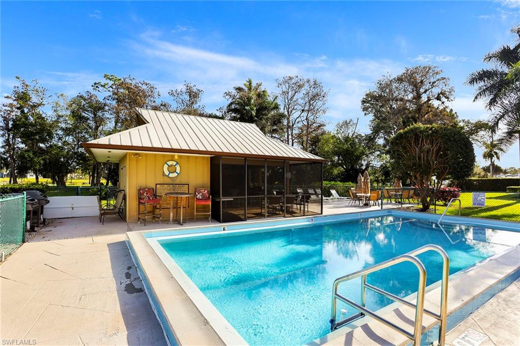 95 St Andrews Boulevard, Unit B209 Naples, FL 34113 - Photo 8 of 18 a view of a house with swimming pool and sitting area