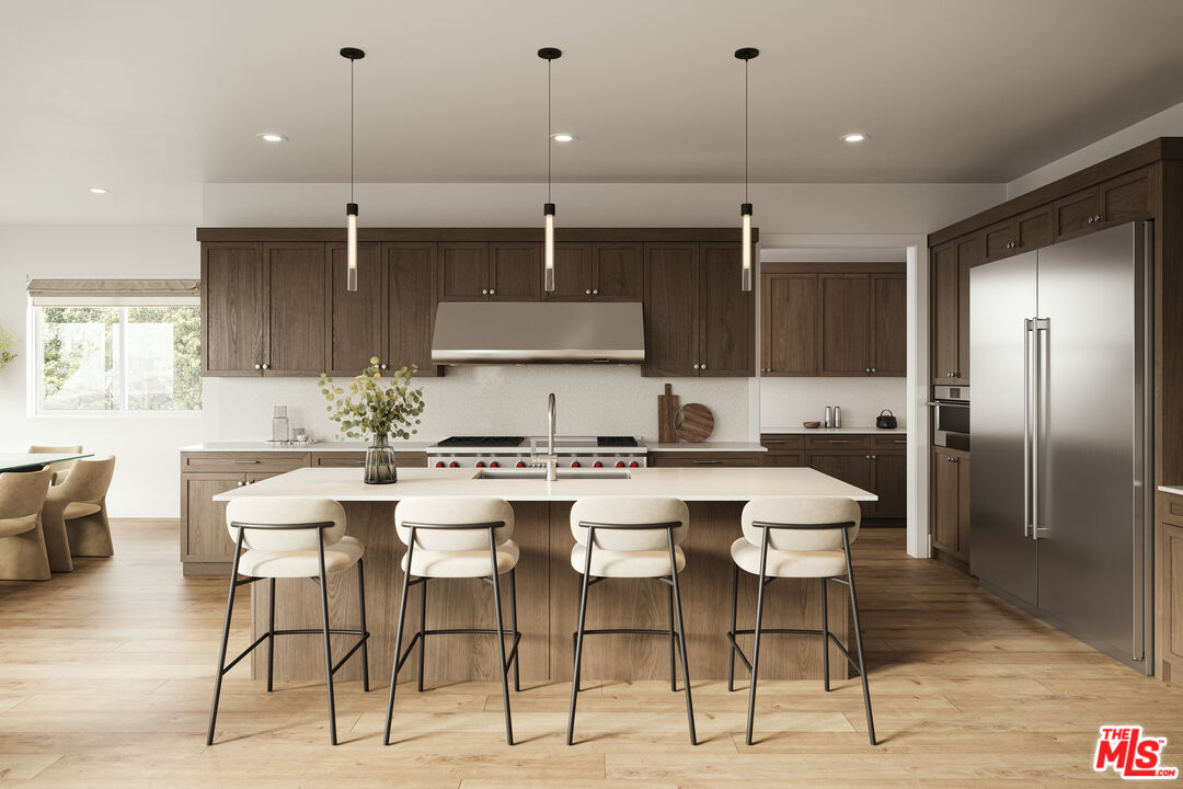 2807 Cardiff Avenue Los Angeles, CA 90034 - Photo 2 of 11 a kitchen with stainless steel appliances kitchen island granite countertop a dining table chairs and sink