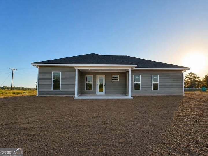 1229 Mark Wood Road Dexter, GA 31019 - Photo 5 of 5 a front view of house with yard and trees in the background