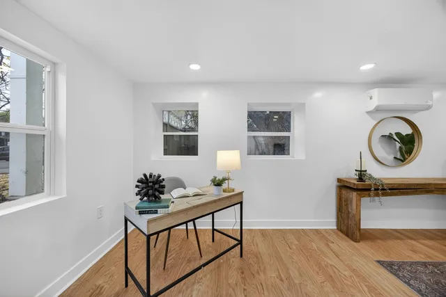 a living room with fireplace furniture and wooden floor