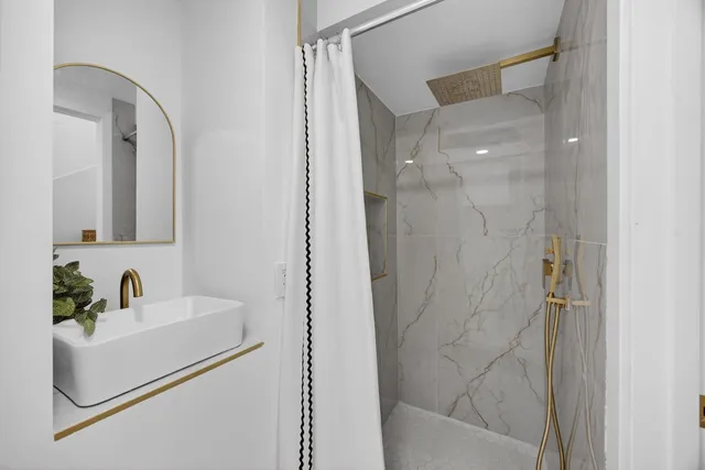 a large kitchen with stainless steel appliances sink a microwave and cabinets