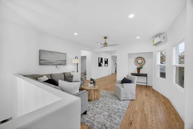 a kitchen with stainless steel appliances a refrigerator and wooden floor