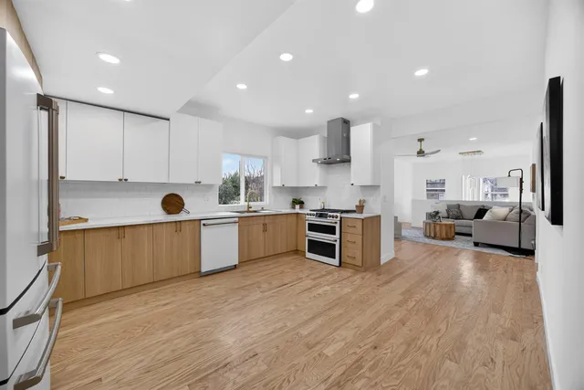 a spacious bathroom with a double vanity sink a mirror and shower