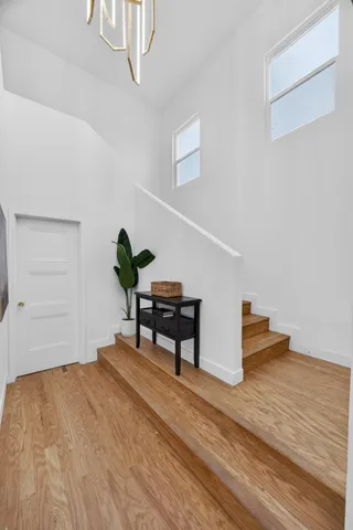 a view of a kitchen with wooden floor and a sink
