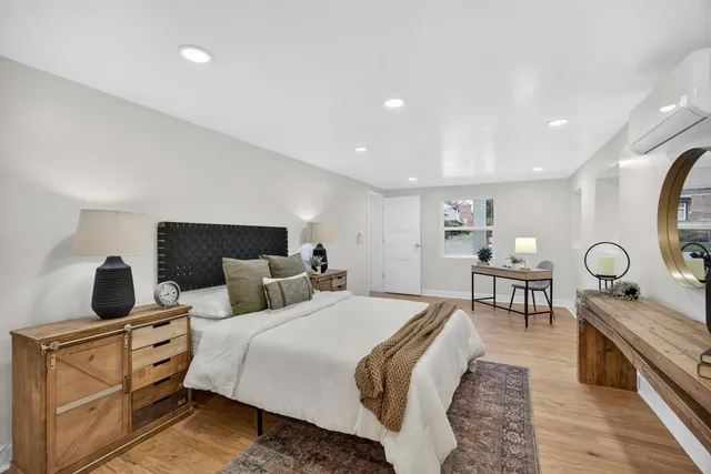 a kitchen with wooden floors and white cabinets