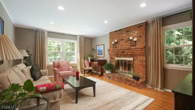a living room with furniture a fireplace and a table