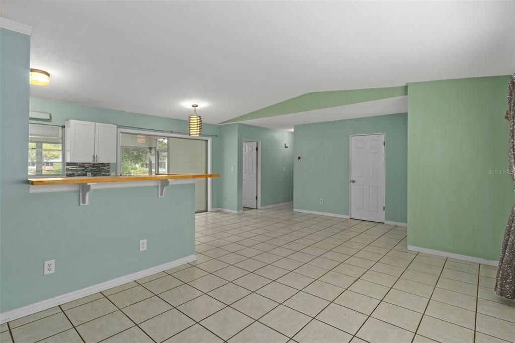 6421 Finance Avenue Weeki Wachee, FL 34607 - Photo 12 of 38 a view of kitchen with refrigerator cabinets and wooden floor