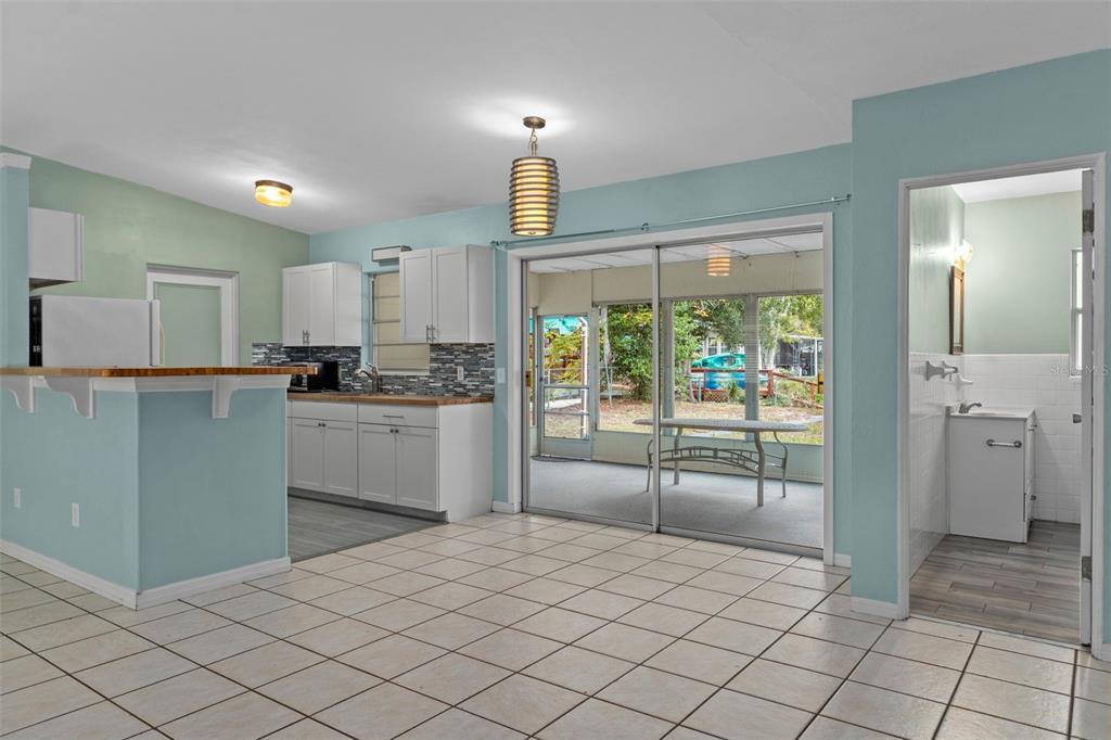 6421 Finance Avenue Weeki Wachee, FL 34607 - Photo 14 of 38 a kitchen with granite countertop a refrigerator and a stove top oven