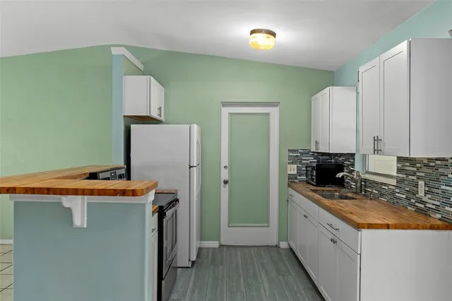 a bathroom with a sink and mirror with bathtub