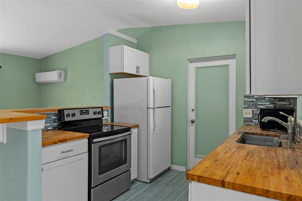 6421 Finance Avenue Weeki Wachee, FL 34607 - Photo 18 of 38 a kitchen with a refrigerator and a stove