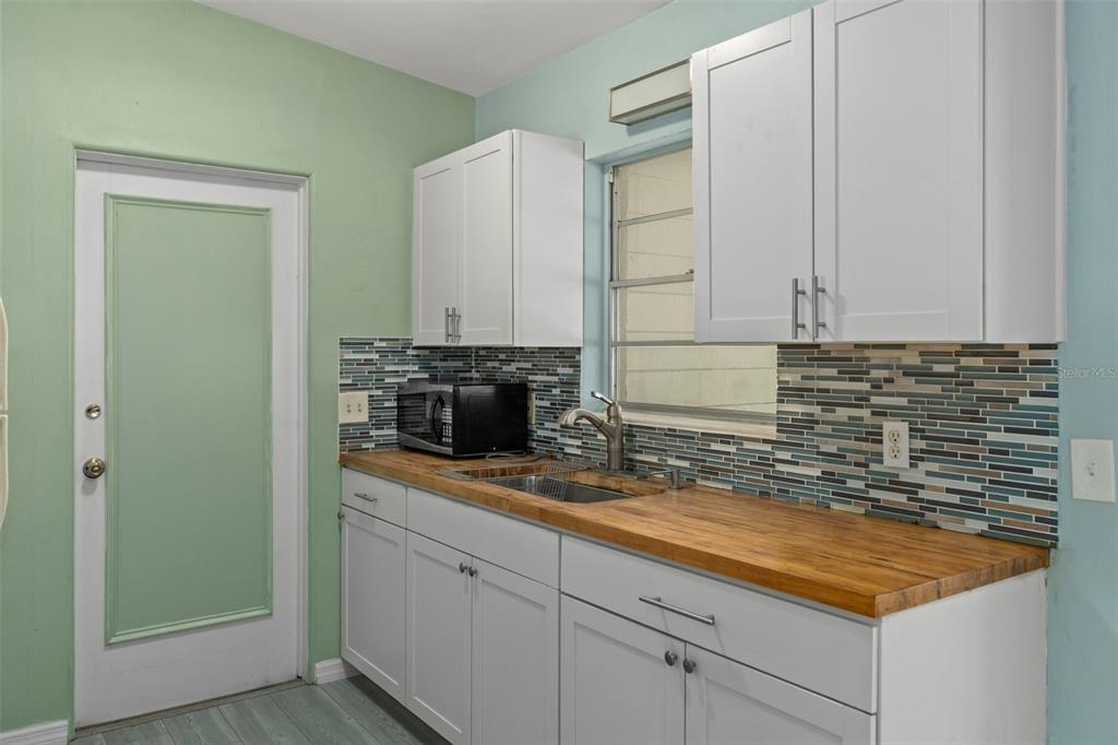 6421 Finance Avenue Weeki Wachee, FL 34607 - Photo 19 of 38 a kitchen with stainless steel appliances granite countertop a sink a stove and a granite counter tops