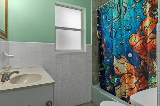 a bathroom with a sink a toilet and mirror