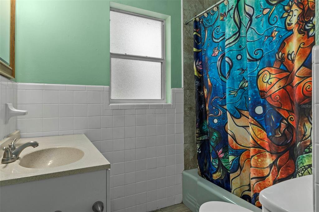 6421 Finance Avenue Weeki Wachee, FL 34607 - Photo 21 of 38 a bathroom with a sink and mirror with bathtub