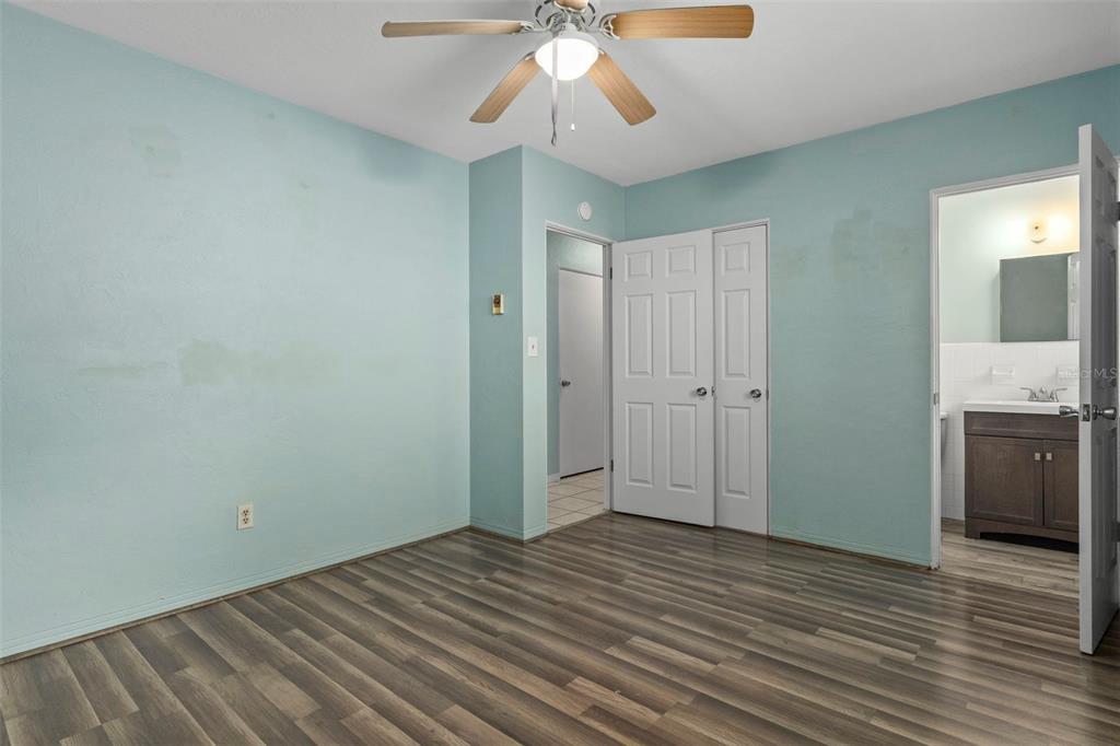 6421 Finance Avenue Weeki Wachee, FL 34607 - Photo 23 of 38 wooden floor in an empty room with a kitchen