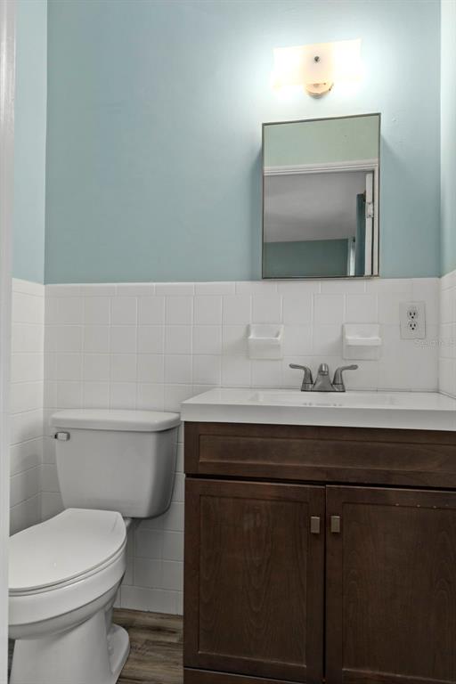 6421 Finance Avenue Weeki Wachee, FL 34607 - Photo 25 of 38 a bathroom with a sink a toilet and mirror