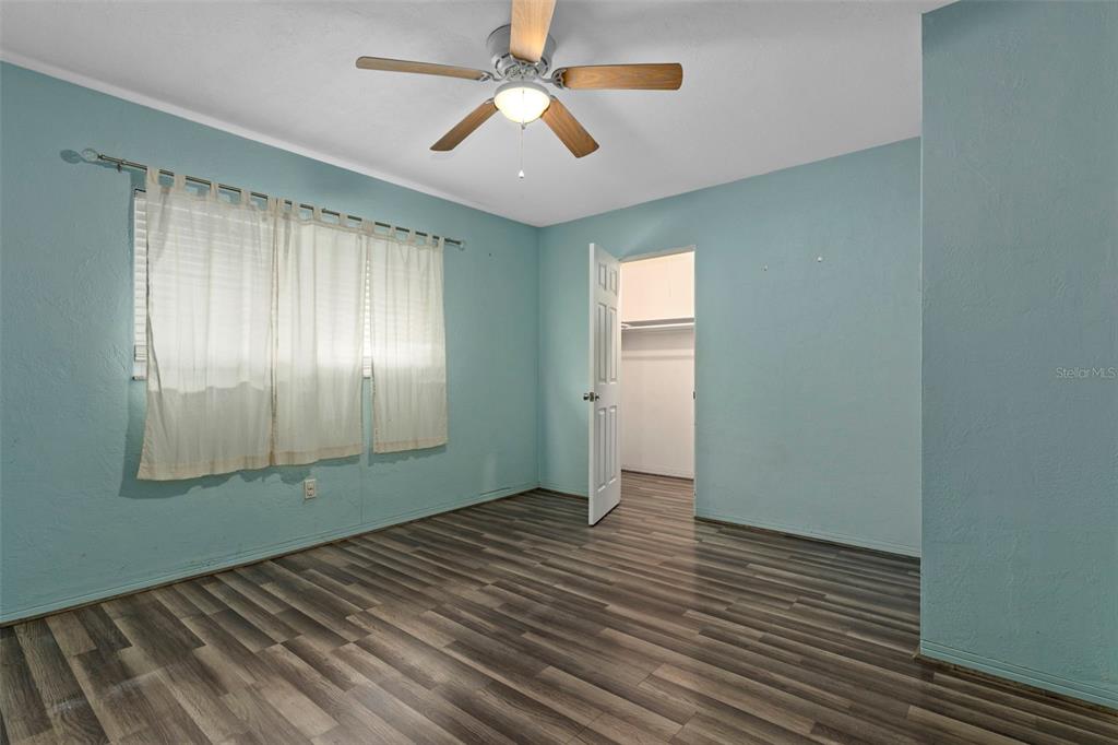 6421 Finance Avenue Weeki Wachee, FL 34607 - Photo 27 of 38 wooden floor in an empty room with a window