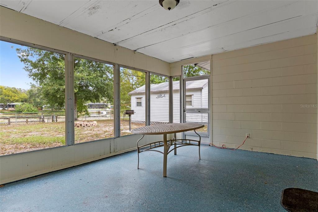 6421 Finance Avenue Weeki Wachee, FL 34607 - Photo 32 of 38 a view of a room with furniture and floor to ceiling window